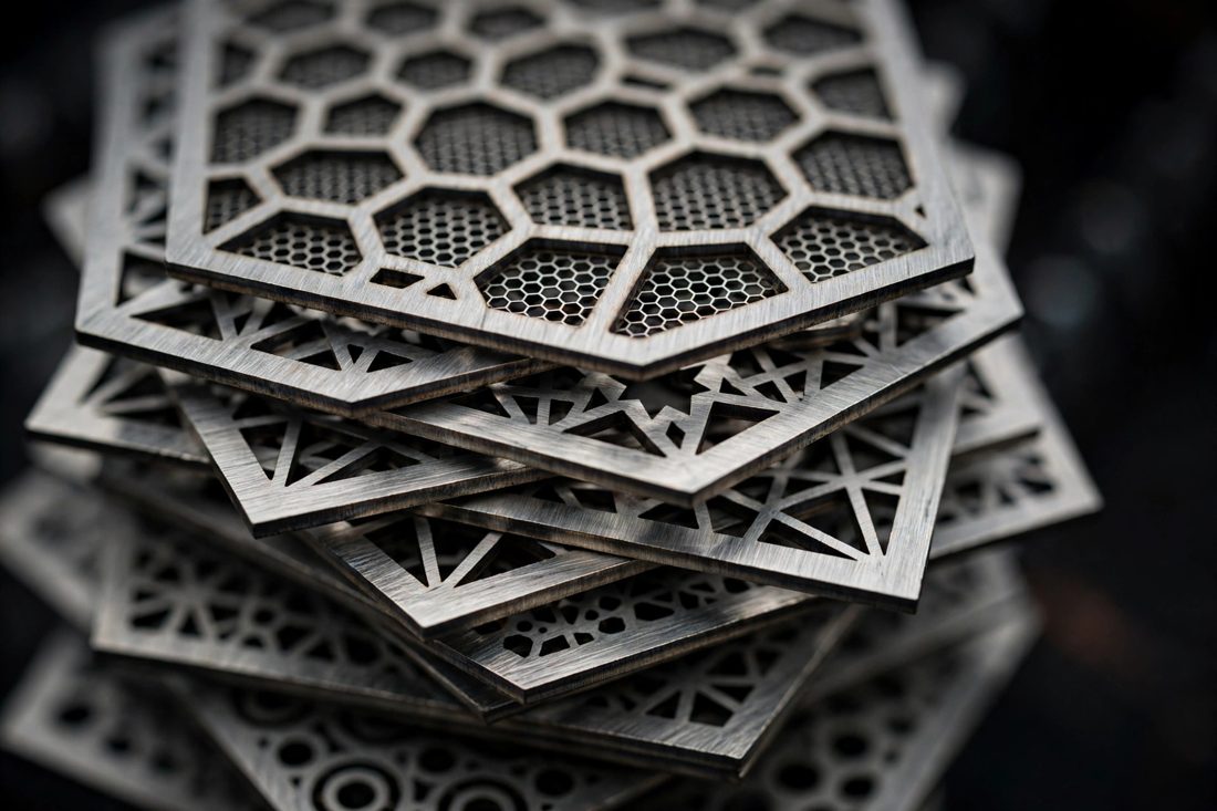 Stack of precision laser-cut stainless steel parts